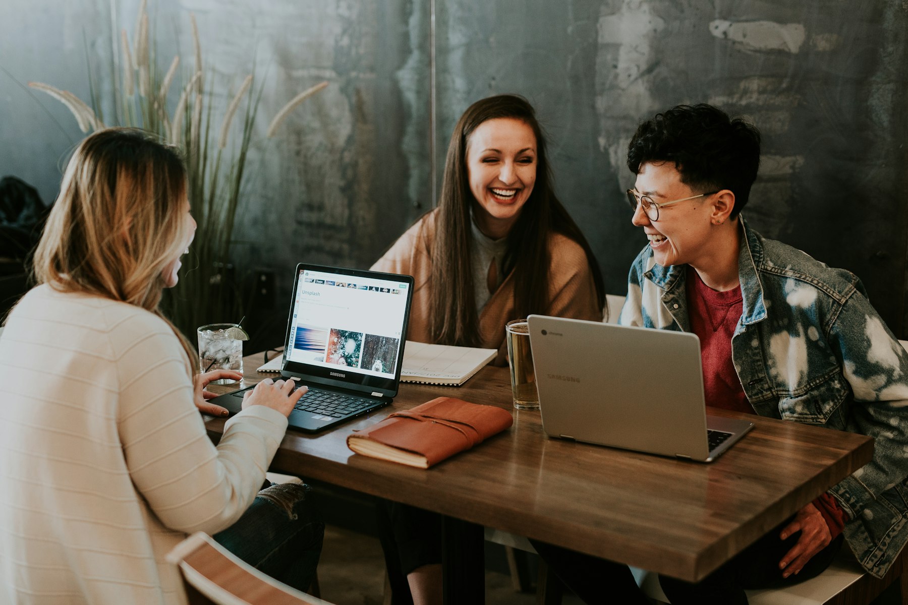 Three people working together around a table
